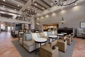 a lobby with couches and tables and a bar at Homewood Suites by Hilton La Quinta in La Quinta