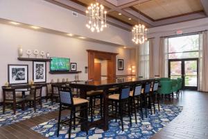 a large dining room with a long table and chairs at Hampton Inn & Suites East Lansing in Okemos