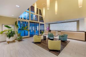 a lobby with chairs and tables and windows at Hilton Vacation Club Cancun Resort Las Vegas in Las Vegas