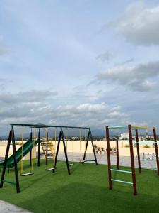 a swing set on the beach with the sand at Naga City Centro perfect Stay in Naga