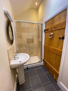 a bathroom with a sink and a shower at The Udderhouse - Udderly Unforgettable Retreat in Donyatt