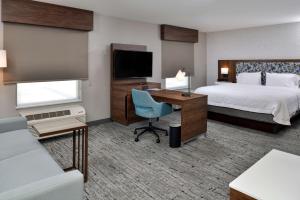 a hotel room with a bed and a desk with a computer at Hampton Inn & Suites Las Vegas Airport in Las Vegas