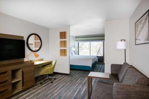 a hotel room with a bed and a desk and a television at Hampton Inn & Suites Las Vegas-Henderson in Las Vegas