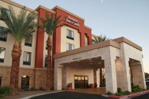 a hotel with palm trees in front of it at Hampton Inn & Suites Las Vegas South in Las Vegas