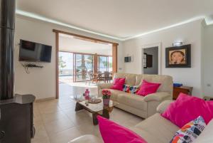a living room with two couches and a tv at Villa Santana in Conil