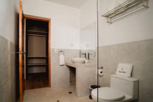a bathroom with a toilet and a sink at Ensenada Hotel y Campo Asociado Casa Andina in Cajamarca +167 photos