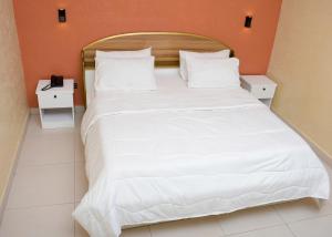 Postel nebo postele na pokoji v ubytování HOTEL MAVILLA Cotonou
