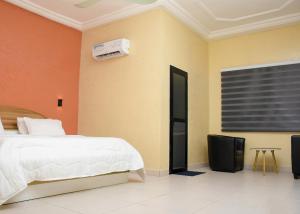 Postel nebo postele na pokoji v ubytování HOTEL MAVILLA Cotonou