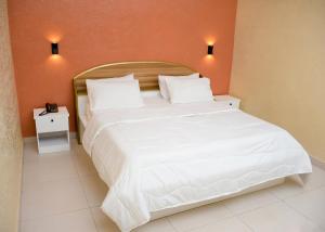 Postel nebo postele na pokoji v ubytování HOTEL MAVILLA Cotonou