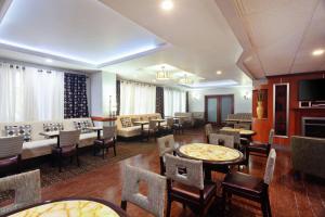 a restaurant with tables and chairs and a living room at Hampton Inn Los Angeles/Arcadia in Arcadia