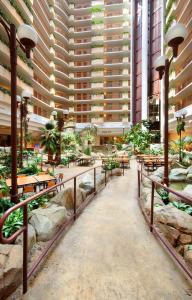 a large building with tables and chairs in a courtyard at Embassy Suites by Hilton Anaheim South in Anaheim