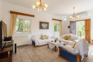 a living room with a couch and a table at Villa Evie in Nisaki