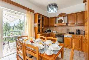 a kitchen with a table and chairs and a dining room at Villa Evie in Nisakion