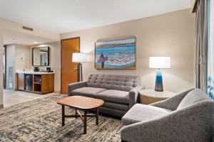 a living room with a couch and a table at Embassy Suites by Hilton Anaheim South in Anaheim