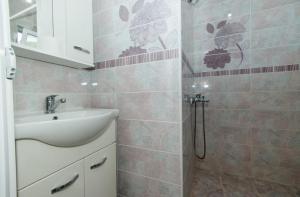 a bathroom with a sink and a shower at Flori Apartments in Ulcinj