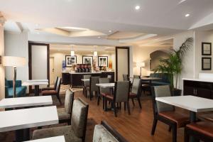 a restaurant with tables and chairs and a bar at Hampton Inn Los Angeles Int'l Airport/Hawthorne in Los Angeles