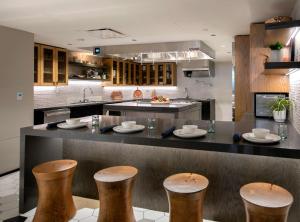 a kitchen with a counter with stools in it at The Wayfarer Downtown LA, Tapestry Collection by Hilton in Los Angeles