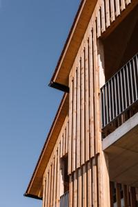 a building with wooden balconies on the side of it at SCHILCHERLANDLEBEN - Hochgrail in Greisdorf