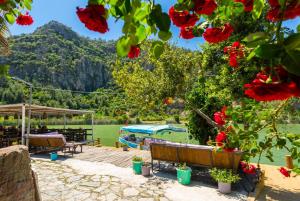 a view from the garden of a house with red flowers at Villa Deniz Paradise in Dalyan