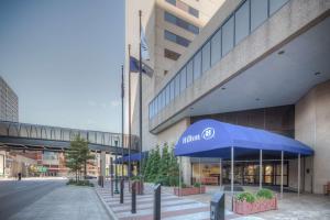 a building with blue umbrellas in front of it at Hilton Lexington Downtown in Lexington