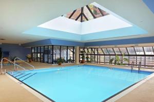 a large swimming pool with a large skylight at Hilton Lexington Downtown in Lexington