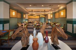 a restaurant with tables and vases on a table at Hilton Lexington Downtown in Lexington