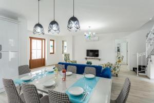 a dining room and living room with a table and chairs at Villa Portakal Blossom in Dalyan