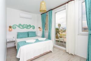 a bedroom with a bed and a large window at Villa Portakal Blossom in Dalyan +47 photos
