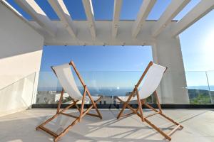 two chairs in a room with a large window at Villa Rosemary in Makarska