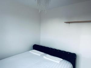 a bedroom with a bed with two white sheets at NANCY 1 in Portsmouth
