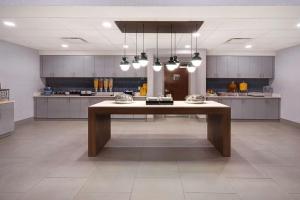 a large kitchen with a large table in the middle at Homewood Suites by Hilton Lexington-Hamburg in Lexington