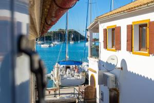 a boat is docked at a dock in the water at Flora Maisonettes 1 in Gaios