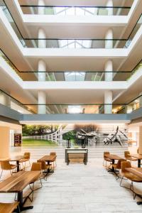 a rendering of a classroom with tables and chairs at Embassy Suites by Hilton Lexington Green in Lexington