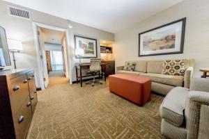 a living room with a couch and a table at Embassy Suites by Hilton Lexington Green in Lexington
