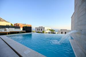 a swimming pool on the roof of a building at Villa Rosemary in Makarska