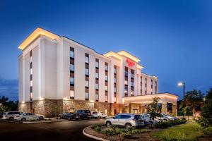 a hotel with cars parked in a parking lot at Hampton Inn By Hilton Paramus in Paramus