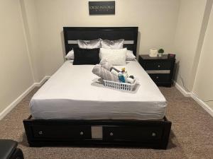 a bedroom with a bed with a basket on it at Home away from home! in Canton