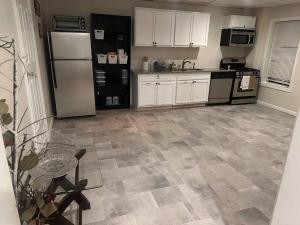 a kitchen with a white refrigerator and a tile floor at Home away from home! in Canton