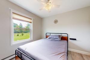 a bedroom with a bed and a window at Cozy Family Home in Penn Yan