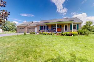 a house with a green lawn in front of it at Cozy Family Home in Penn Yan