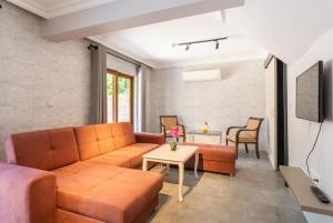 a living room with a couch and a table at Villa Derya Paradise in Dalyan