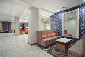a waiting room with a couch and a mirror at Hampton Inn And Suites Logan, Ut in Logan