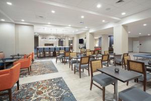 a restaurant with tables and chairs and a bar at Hampton Inn And Suites Logan, Ut in Logan