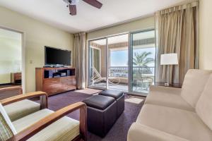 a living room with a couch and a tv at Hilton Vacation Club The Point at Poipu Kauai in Koloa