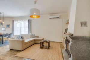 a living room with a couch and a fireplace at Quinta do Quartel in Évora