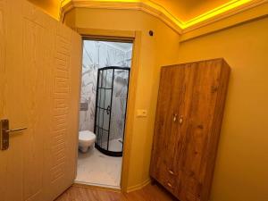 a bathroom with a toilet and an open door at pilot hotel in Arnavutköy