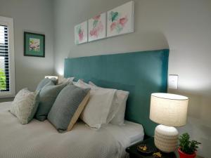 a bedroom with a bed with a blue headboard at Stay Taupo in Taupo