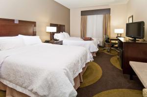 a hotel room with two beds and a flat screen tv at Hampton Inn Maumelle in Maumelle +26 photos