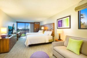 a hotel room with a bed and a couch at Hilton Garden Inn Kauai Wailua Bay, HI in Kapaa