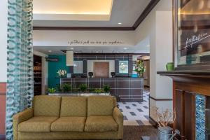 a lobby with a couch and a bar at Hilton Garden Inn North Little Rock in North Little Rock